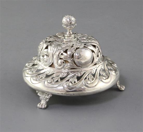 A late Victorian pierced and repousse silver table bell by Samuel Walton Smith, 11.6cm.